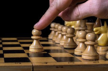 game of chess, chess player of makes the first move a pawn, isolated black background