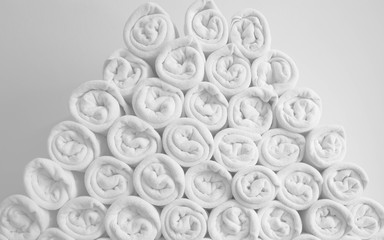 Rolled up white spa towels or bath towels keep in store room .