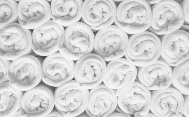 Rolled up white spa towels or bath towels keep in store room .