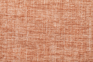 Orange fluffy background of soft, fleecy cloth. Texture of textile closeup.