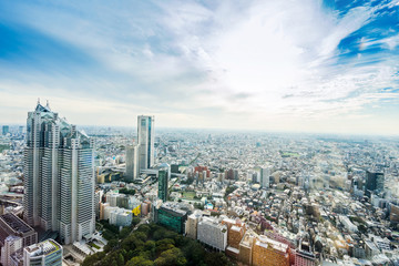 Naklejka premium Business and culture concept - panoramic modern city skyline bird eye aerial view under dramatic sun and morning blue cloudy sky in Tokyo, Japan