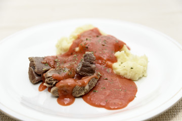 Homemade tomato sauce with mashed potatoes and boiled beef