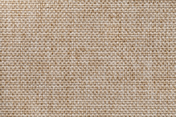 Light brown textile background closeup. Structure of the fabric macro