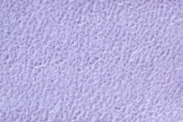 Light purple fluffy background of soft, fleecy cloth. Texture of textile closeup