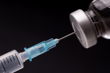 Medical syringe with the needle in the vial