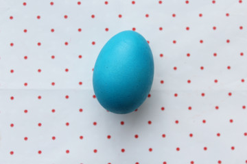 Easter egg on polka dot background