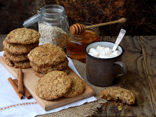 Flourless gluten free peanut butter, oatmeal, honey, dried fruits cookies and cup of cocoa with...