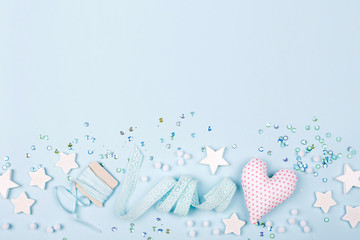 Stylish Frame border with cute decoration: heart, lace ribbon, stars and sequins with copy space for text on blue background