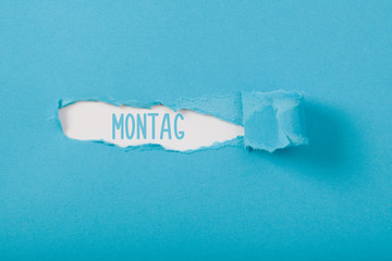Montag (Monday) German weekday message on Paper torn ripped opening