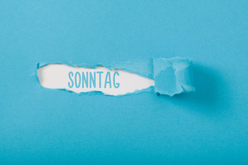 Sonntag (German Sunday) weekday message on Paper torn ripped opening