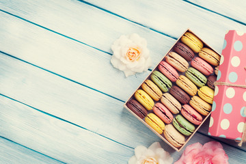 Colorful macaroons in a gift box and roses