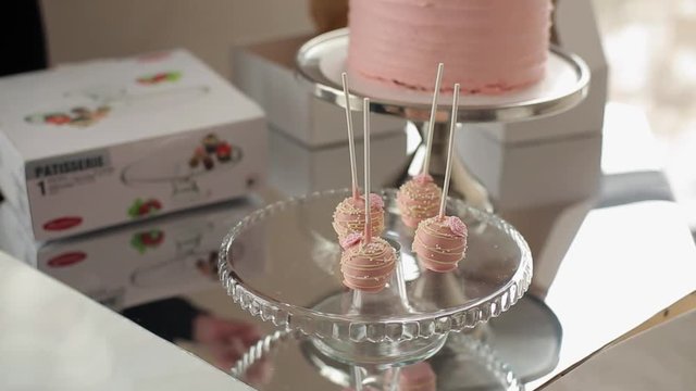 Pink sweets and cake on plate