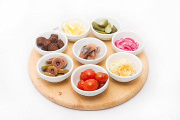 Appetizers in small plates on white background