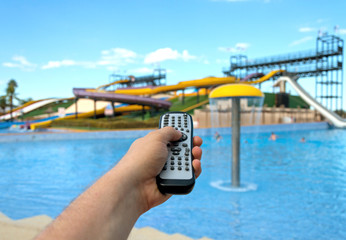 Obraz premium Magic remote control. Image that you can choose anything you want, for example your vacations in water park.