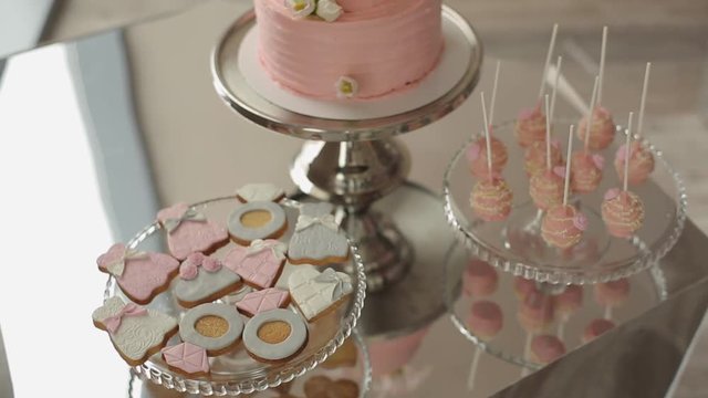 Pink sweets and cake on plate