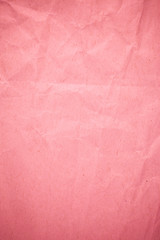 Crumpled recycle pink paper background.