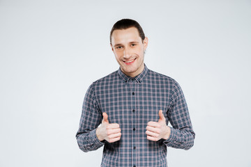 Smiling man in shirt showing thumbs up