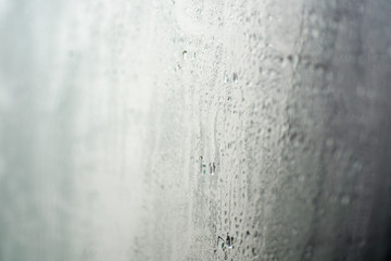 Drops of water on wet window.