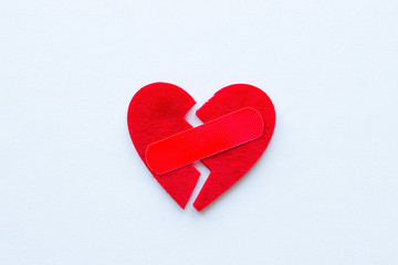 broken heart with a patch on a white background closeup