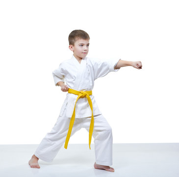 Boy with yellow belt beats punch arm