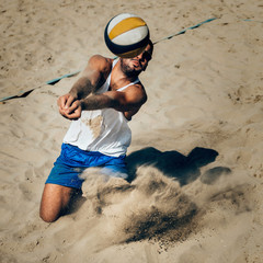 Male beach volleyball player in action © Microgen