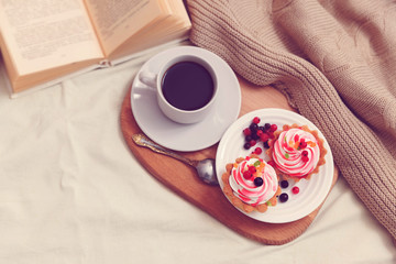 Cake with cream and berries for breakfast in bed