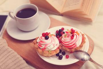 Cake with cream and berries for breakfast in bed