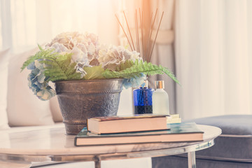 Modern workplace with tree pot and reed freshener on coffee table