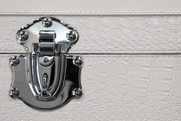 Detail of trunk lock in metal and leather