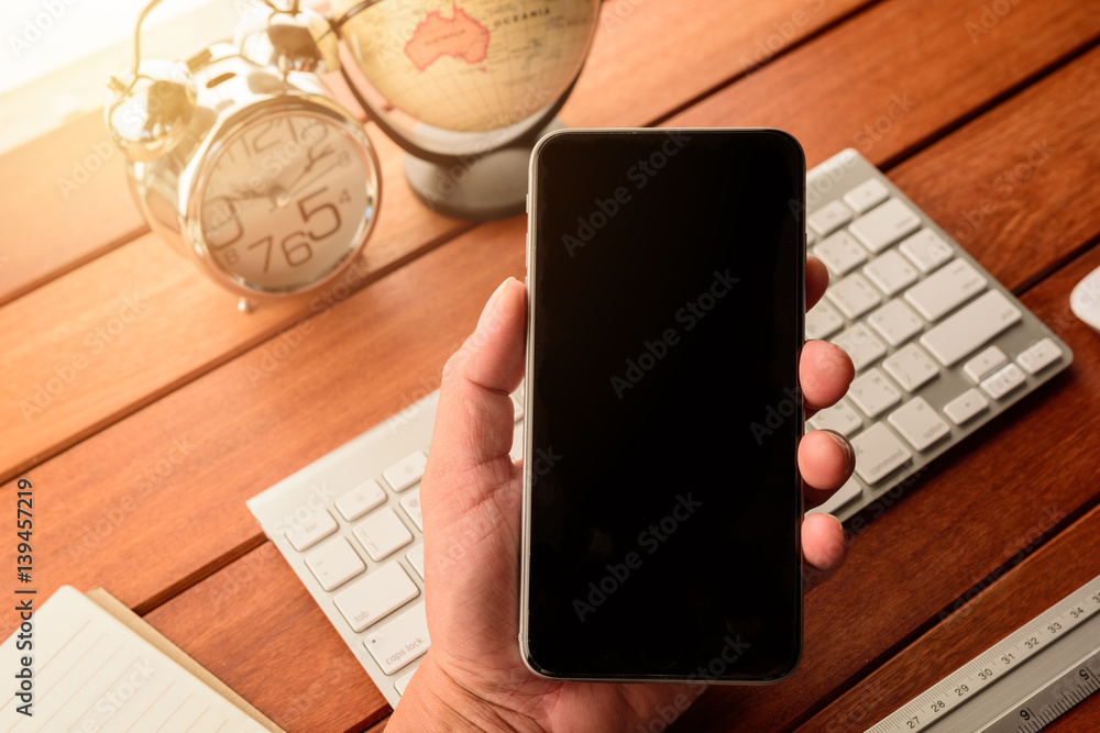 Aufkleber hand use smart phone with blank empty screen top view