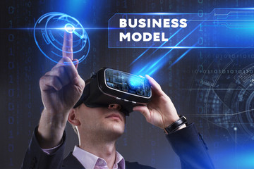 Business, Technology, Internet and network concept. Young businessman working in virtual reality glasses sees the inscription: Business model