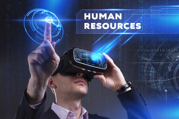 Business, Technology, Internet and network concept. Young businessman working in virtual reality glasses sees the inscription: Human resources