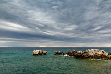 cloudy day in the late afternoon on the sea coast in the summer among the rocks.