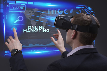 Business, Technology, Internet and network concept. Young businessman working on a virtual screen of the future and sees the inscription: Online marketing