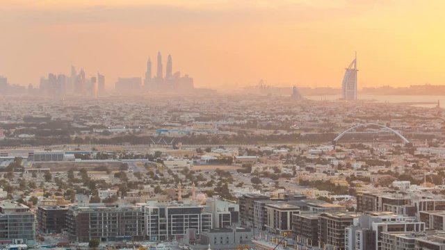 Dubai skyline with Dubai Marina skyscrapers and coastline at sunset timelapse with seven star luxury hotel in Dubai, UAE.