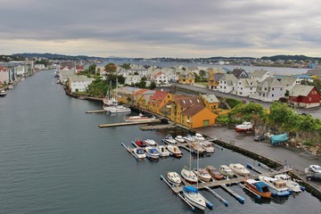 Fototapeta na wymiar Panoramic view of the strait Smedasund in Haugesund. On the right historic herring export buildings (orange). Norway, Scandinavia, Europe.