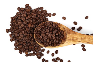 pile coffee beans and wooden spoon isolated on white, top view 