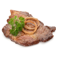 Cooked fried pork meat with parsley herb leaves and onion slices garnish isolated on white background cutout