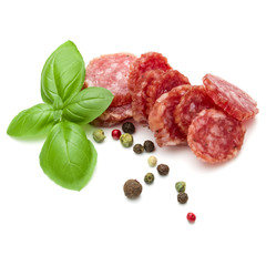 Salami smoked sausage slices, basil leaves and peppercorns isolated on white background cutout