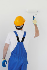Worker painting wall