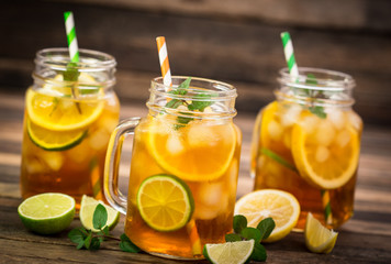 Fototapeta na wymiar Ice tea with lemon, lime and mint