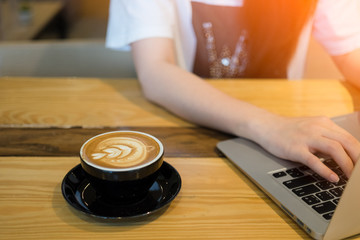 Fototapeta na wymiar Woman using computer laptop in coffee shop