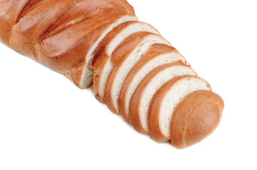 Fresh loaf sliced on a white background