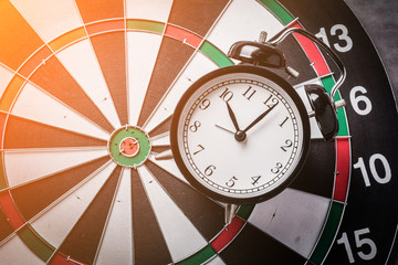 dartboard and black alarmclock with business stretegy ideas concept