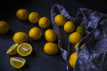 Ripe lemons in bag with knife