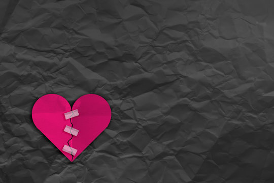 heart broke with tape fix and Crumpled fold white paper sheet background love problem concept