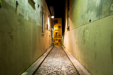 An alley in the Montmartre district of Paris, France on a summer night.