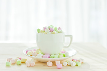 coffee cup with marshmallows on a light background