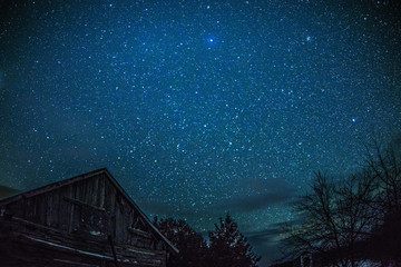 Rural Log Cabin barn at night with stars and milky way - Powered by Adobe