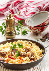 Pilaf with beef, carrots, onions, garlic, pepper and cumin. A traditional dish of Asian cuisine. Selective focus